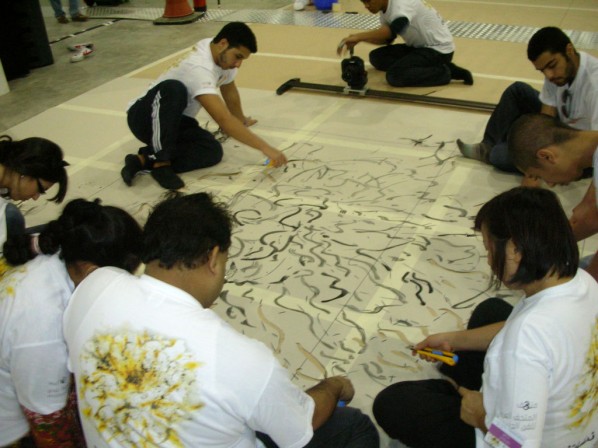 Here are some volunteers making his painting into a stencil.