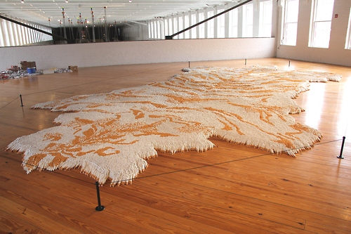 1st Class, Some 500,000 cigarettes forming an ersatz tiger skin rug Courtesy MASS MoCA ©Xu Bing