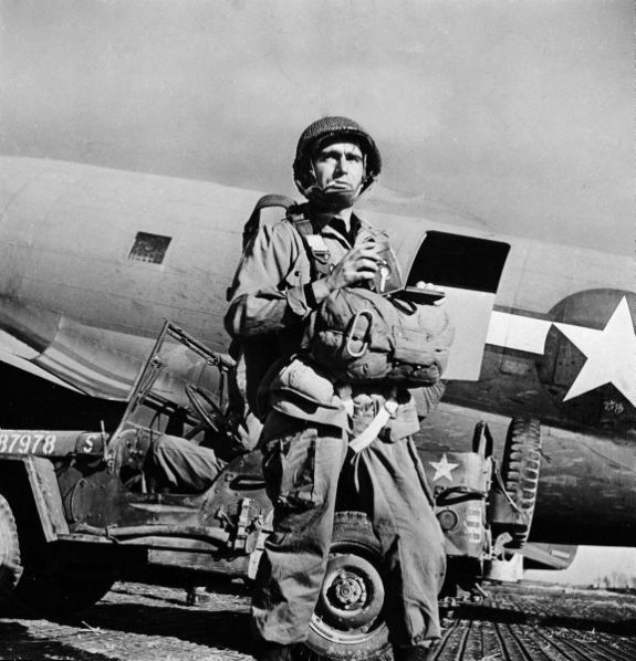 Photographer Robert Capa in gear, preparing to jump in with the troops in WW2, 1945