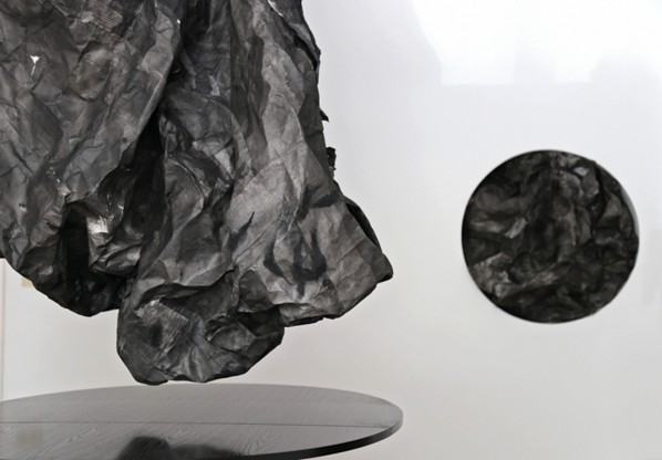 Installation view at Officina’s dining room: on left side, detail of Between Inhale and Exhale, Installation, Xuan paper, ink, light and plastic bag, 90x130x310 cm, 2014. On right side, Between Day and Night #2, Installation, Xuan paper and ink, 87(diameter)x20 cm,2014 © Lin Yan, courtesy Officina and Fou Gallery.